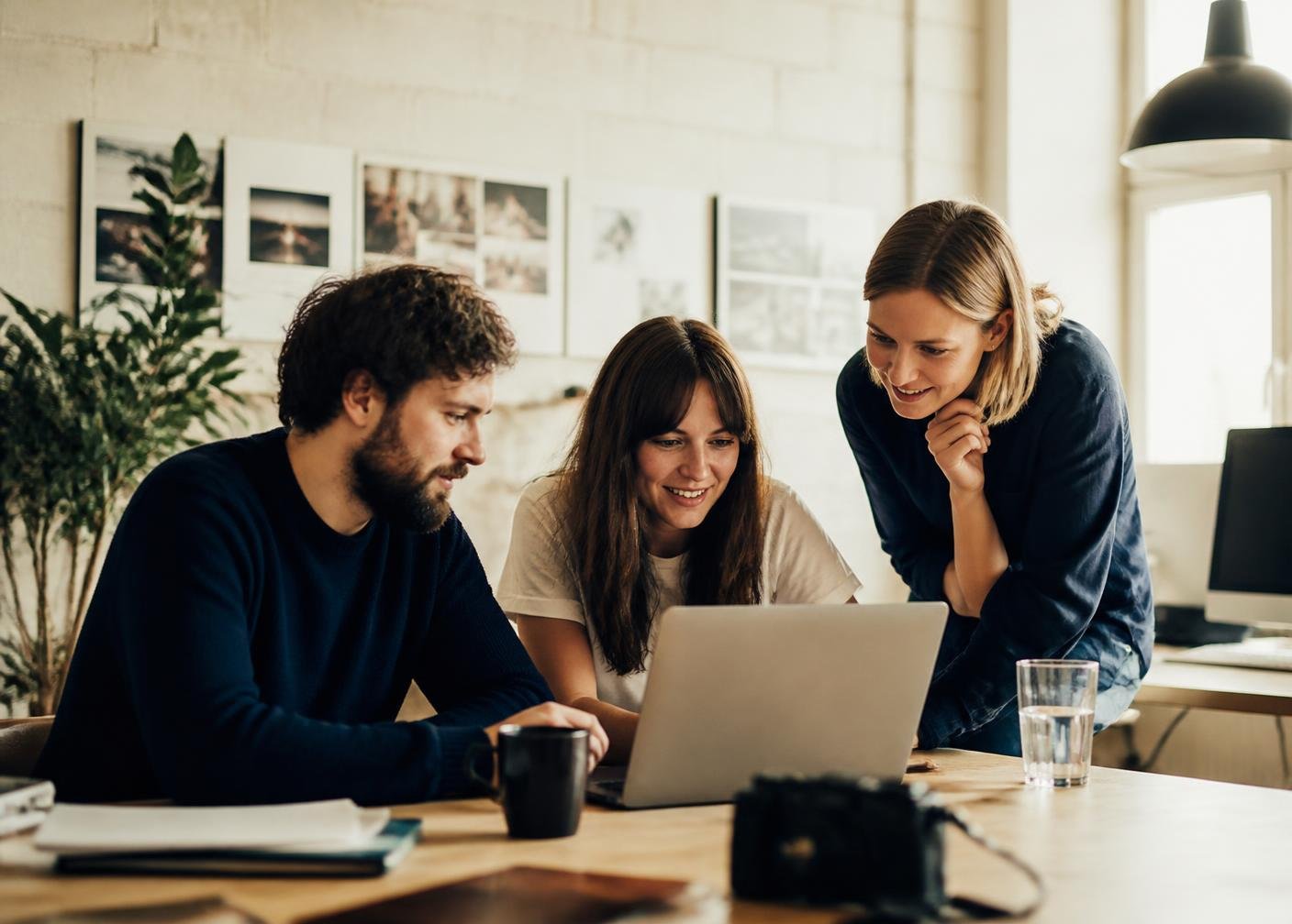 A small team handling an enquiry together on a laptop